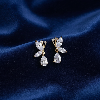 Pair of diamond earrings on a blue velvet background